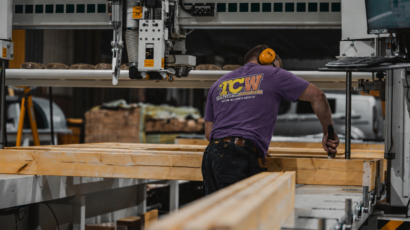 Total Custom Woodworking team member working with timber in the workshop