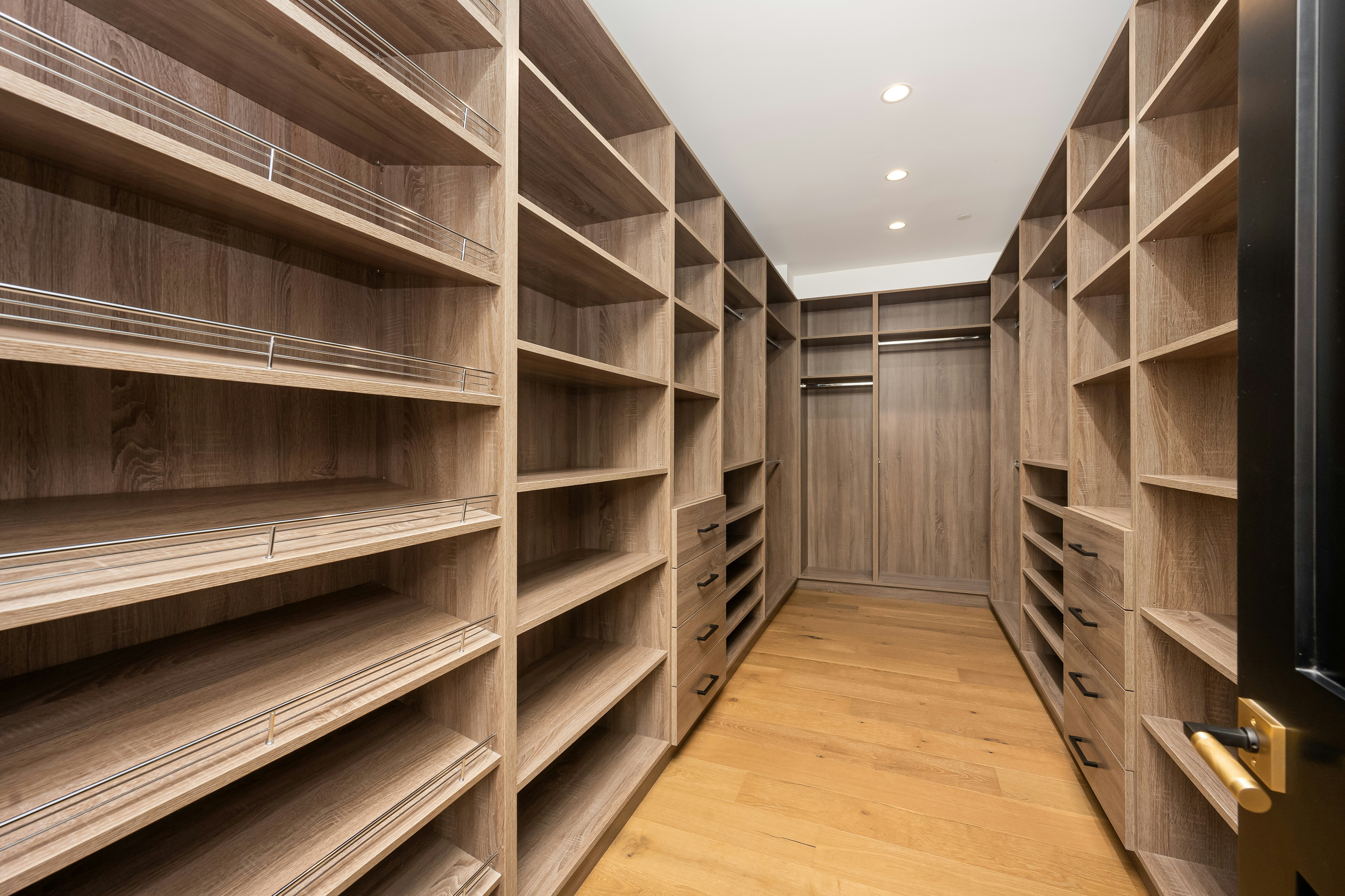 Luxury walk-in closet by Total Custom Woodworking