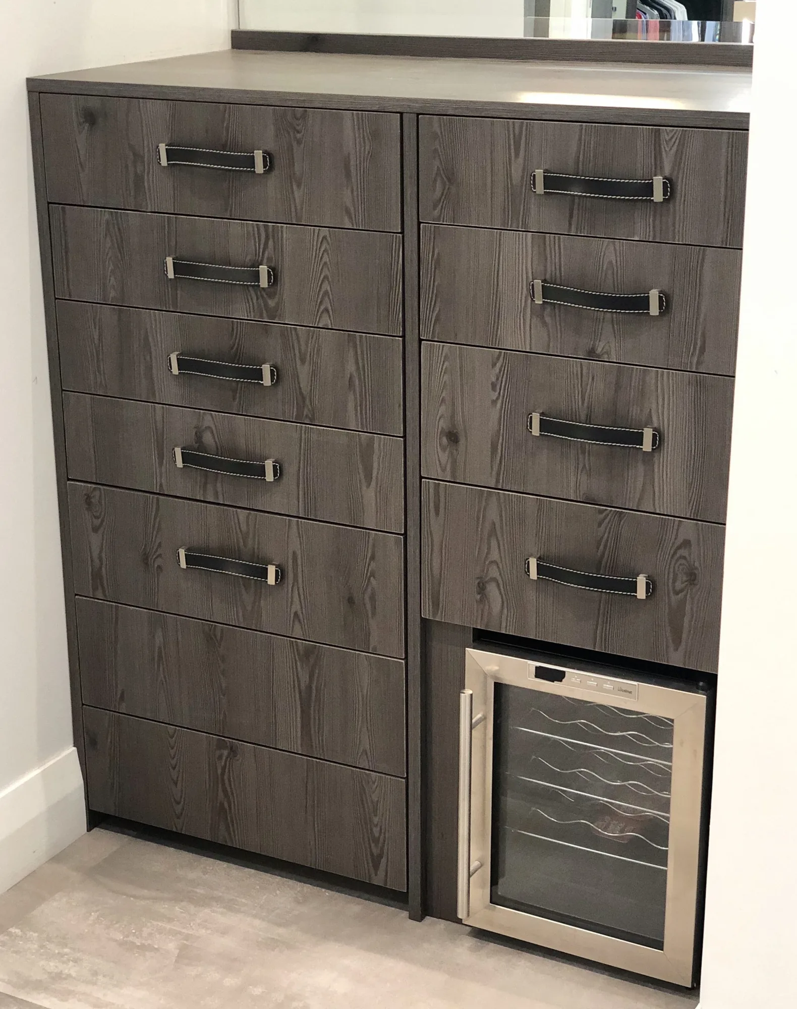 Dark wood drawer cabinet with integrated wine refrigerator