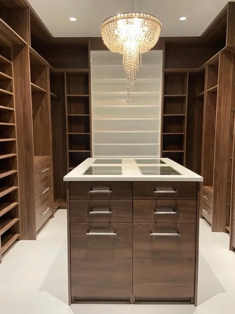 Walk-in closet with central island and shelving
