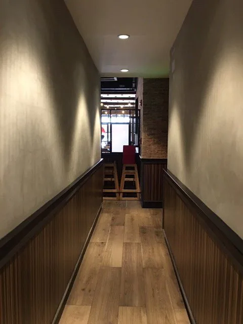 Timber wall cladding in a corridor