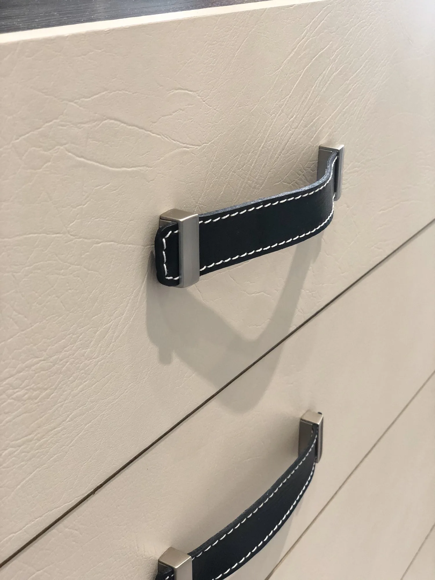 Close-up of cabinet handle and drawer front
